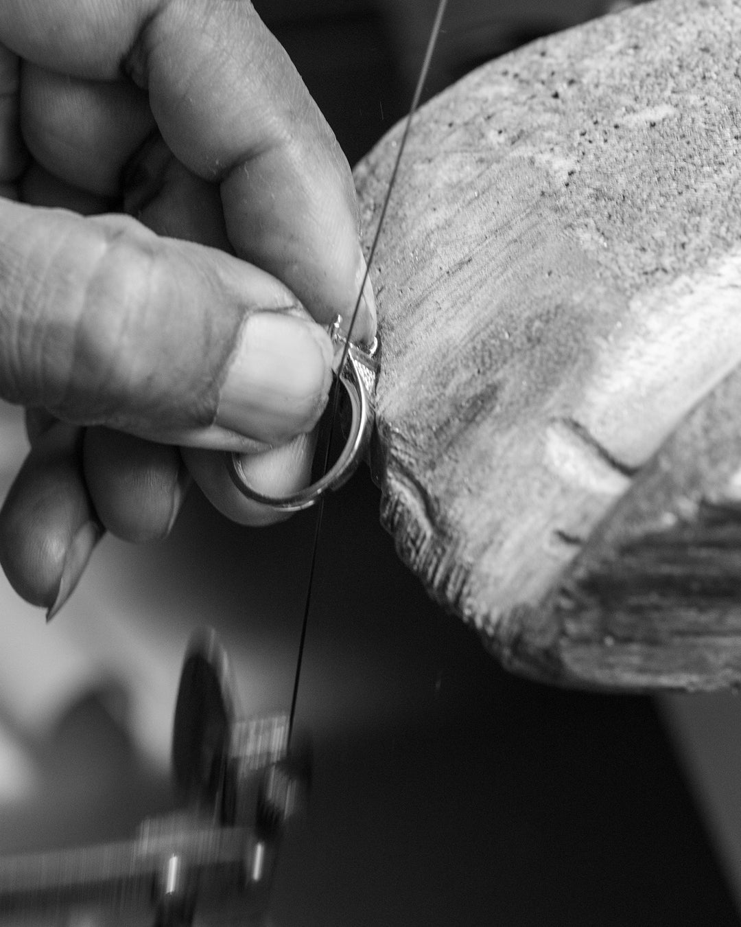 Close-up of a Saint Stones model’s hand threading a needle, styled for detailed jewelry craftsmanship photography in Colorado